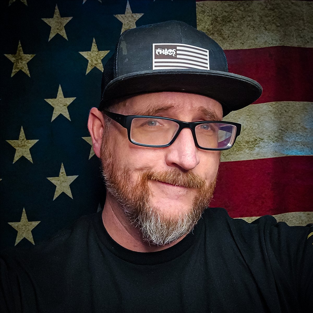 Christopher Chaos in front of an American flag